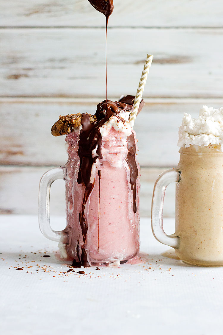Freakshake - Decadent Vegan Milkshakes | Two delicious flavours - Macadamia, Banana & Vanilla topped with Peanut Butter Caramel and Almond Popcorn, and a Chocolate and Strawberry, topped with vanilla whipped coconut cream and Chocolate Fudge Sauce. The perfect dessert for the summer! #vegan #glutenfree