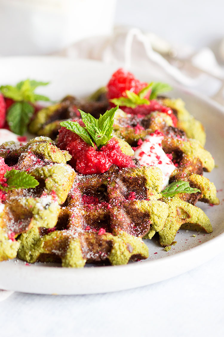 Matcha Waffles with Rasberry Coulis | Gluten free and paleo waffles that are high in protein and taste utterly delicious. The perfect post-workout meal!